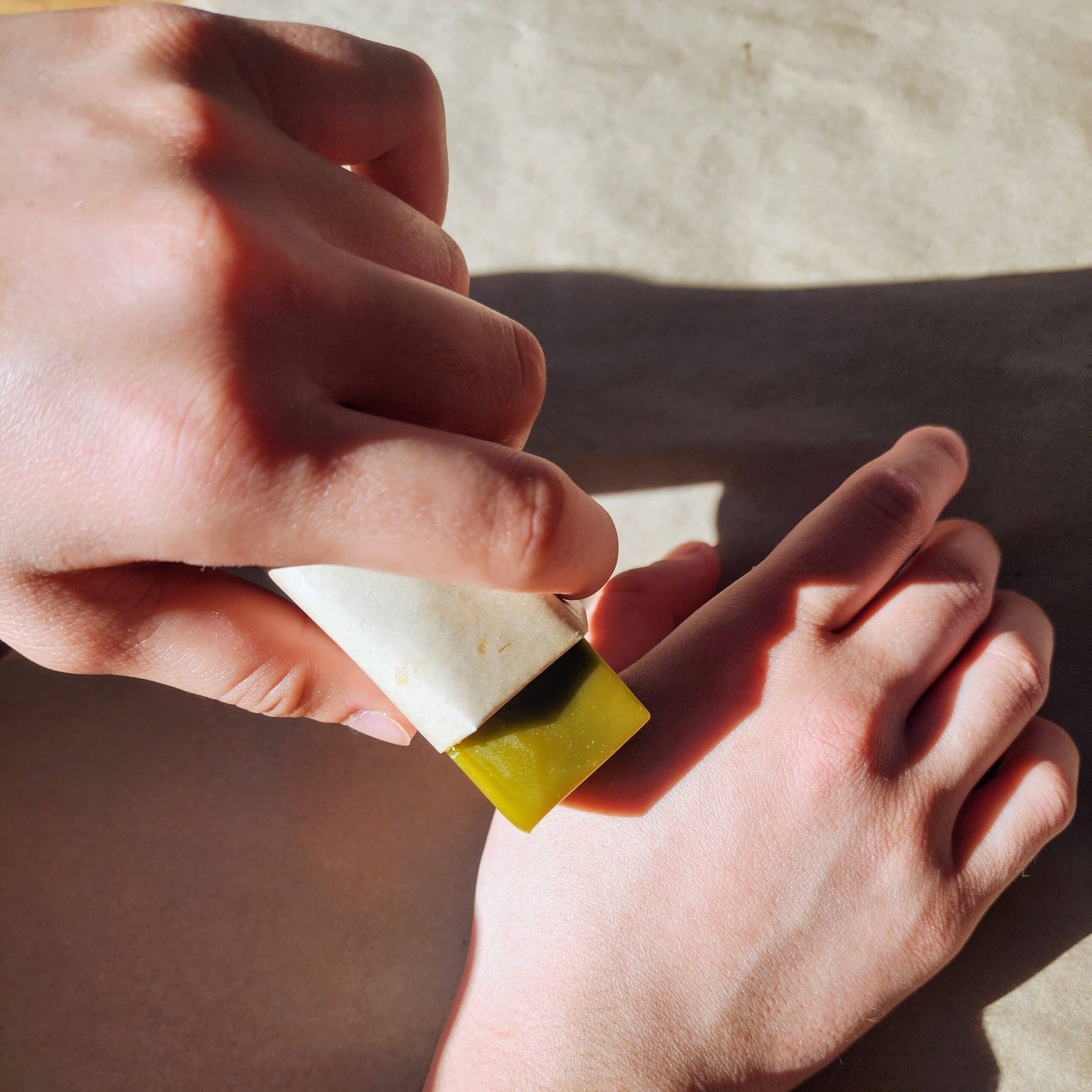 Kawakawa Skincare Stick used on a hand